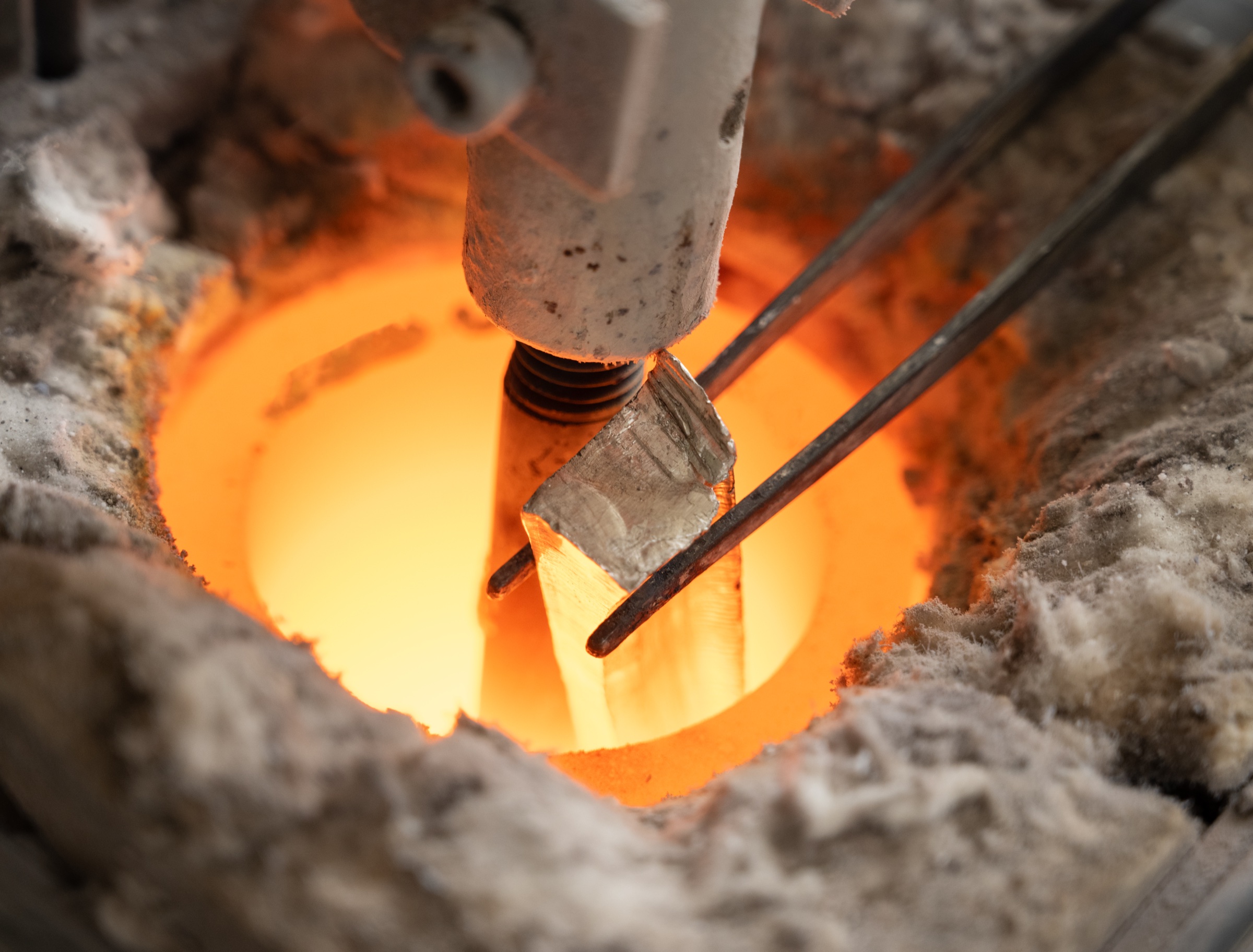Sterling silver melting in the glowing crucible during casting